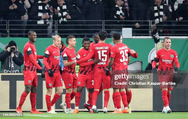 Randal Kolo Muani of Frankfurt celebrates scoring his team's first goal with his team mates during the DFB Cup round of 16 match between Eintracht...