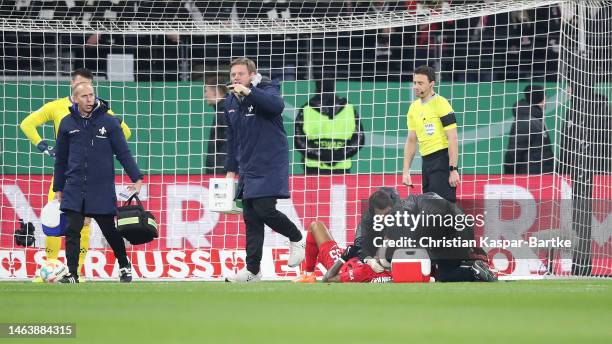 Tuta of Frankfurt receives treatment during the DFB Cup round of 16 match between Eintracht Frankfurt and SV Darmstadt 98 at Deutsche Bank Park on...