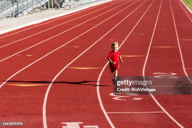 young child running on track - single track stock pictures, royalty-free photos & images