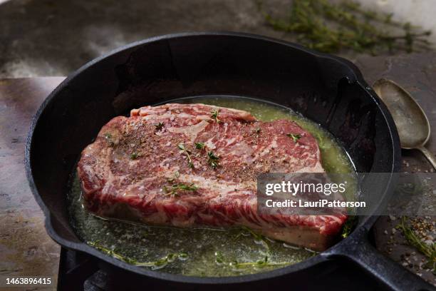 pan searing beef eye rib steak - cast iron stock pictures, royalty-free photos & images