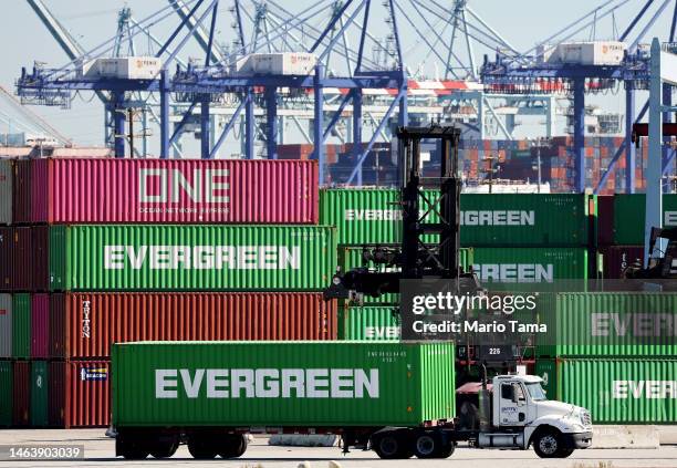 Truck drives near shipping containers stacked at the Port of Los Angeles on February 7, 2023 in Los Angeles, California. The Commerce Department...