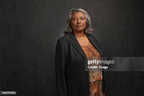 portrait of confident senior woman - leanincollection stockfoto's en -beelden