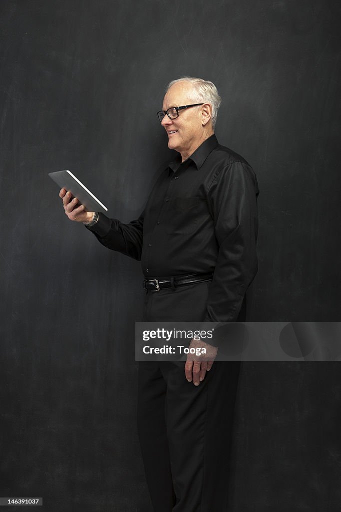 Senior male using digital tablet