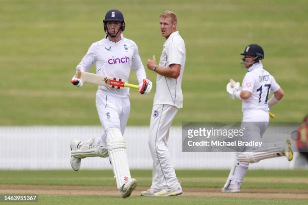 England’s Zak Crawley and Ben Duckett make a run as Kyle Jamieson of the New Zealand XI looks on during day one of the Tour match between New Zealand...
