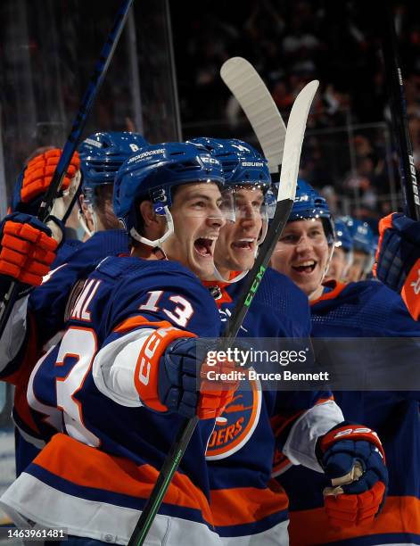 Mathew Barzal, Bo Horvat and Sebastian Aho of the New York Islanders celebrate Horvat's first goal for the team against the Seattle Kraken at UBS...