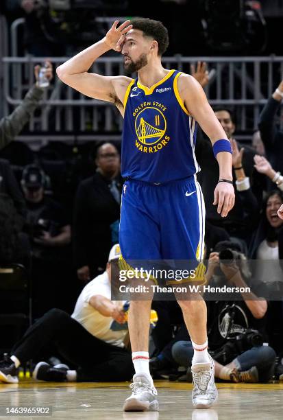 Klay Thompson of the Golden State Warriors reacts after making a three-point shot against the Oklahoma City Thunder during the fourth quarter at...