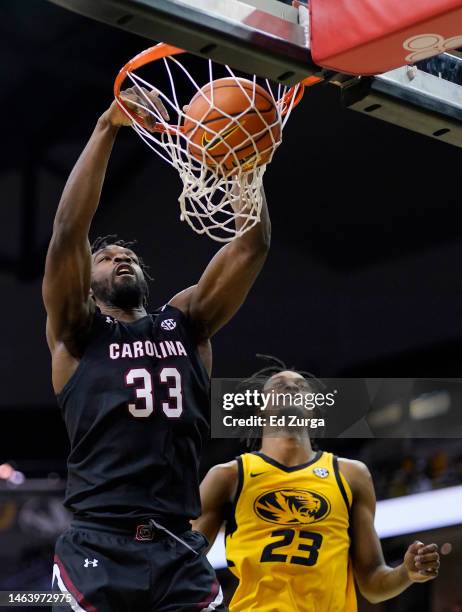 Josh Gray of the South Carolina Gamecocks dunks against Aidan Shaw of the Missouri Tigers in the first half at Mizzou Arena on February 07, 2023 in...