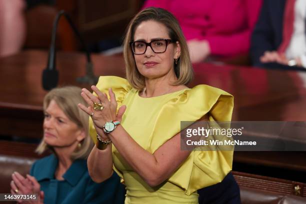 Sen. Kyrsten Sinema applauds during U.S. President Joe Biden's State of the Union address during a joint meeting of Congress in the House Chamber of...