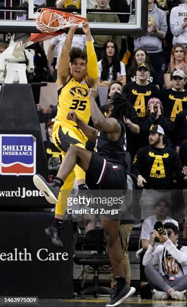 Noah Carter of the Missouri Tigers dunks against Josh Gray of the South Carolina Gamecocks in the first half at Mizzou Arena on February 07, 2023 in...