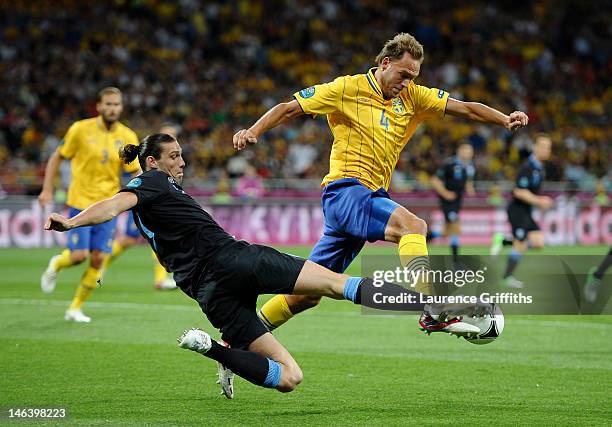 Andreas Granqvist of Sweden is tackled by Andy Carroll of England during the UEFA EURO 2012 group D match between Sweden and England at The Olympic...