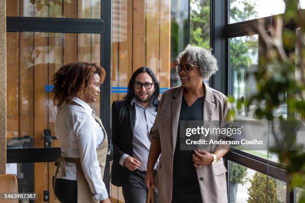 waitress welcoming customers in sophisticated restaurant - gala table stock pictures, royalty-free photos & images