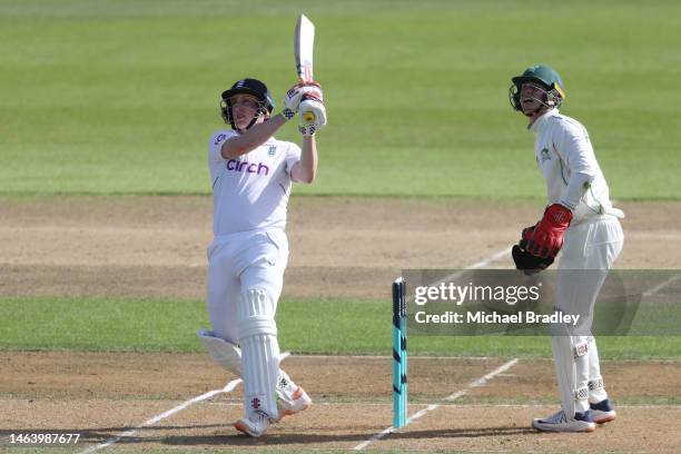 Harry Brook of England plays a shot watched by Curtis Heaphy of the New Zealand XI during day one of the Tour match between New Zealand XI and...