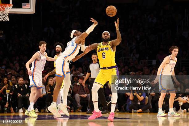 Shai Gilgeous-Alexander of the Oklahoma City Thunder and LeBron James of the Los Angeles Lakers compete for a loose ball at Crypto.com Arena on...