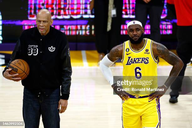 Kareem Abdul-Jabbar stands on court with LeBron James of the Los Angeles Lakers after James passed Abdul-Jabbar to become the NBA's all-time leading...