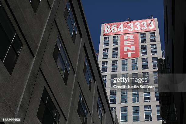 Large "rent" banner is posted on the side of an apartment building on June 15, 2012 in San Francisco, California. According to a report by Harvard...