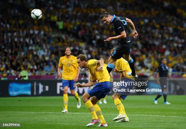 Andy Carroll of England heads the first goal during the UEFA EURO 2012 group D match between Sweden and England at The Olympic Stadium on June 15,...