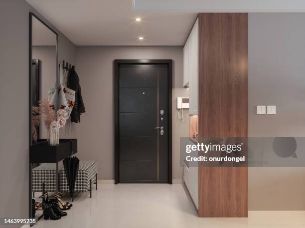 front door entrance to house with hassock, cabinets, coat hook and mirror in corridor - home front stockfoto's en -beelden