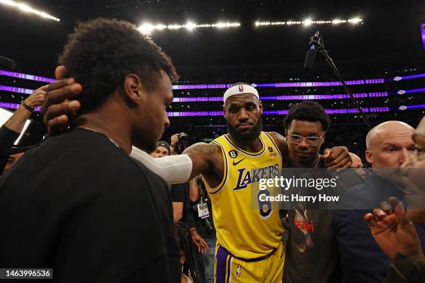 LeBron James of the Los Angeles Lakers reacts with Bronny James and Bryce James after scoring to pass Kareem Abdul-Jabbar to become the NBA's...