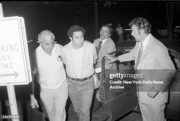 Police escort handcuffed Son of Sam suspect David Berkowitz into Police headquarters in lower Manhattan.