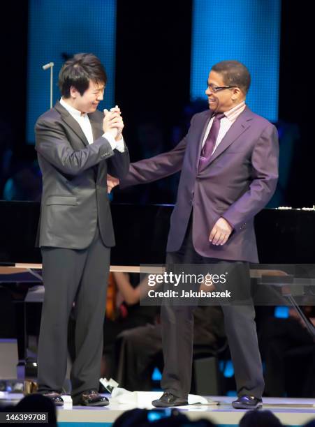 Chinese pianist Lang Lang and US pianist Herbie Hancock perform live during a concert at the O2 World on June 15, 2012 in Berlin, Germany.
