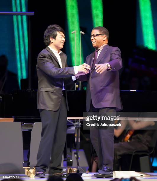 Chinese pianist Lang Lang and US pianist Herbie Hancock perform live during a concert at the O2 World on June 15, 2012 in Berlin, Germany.