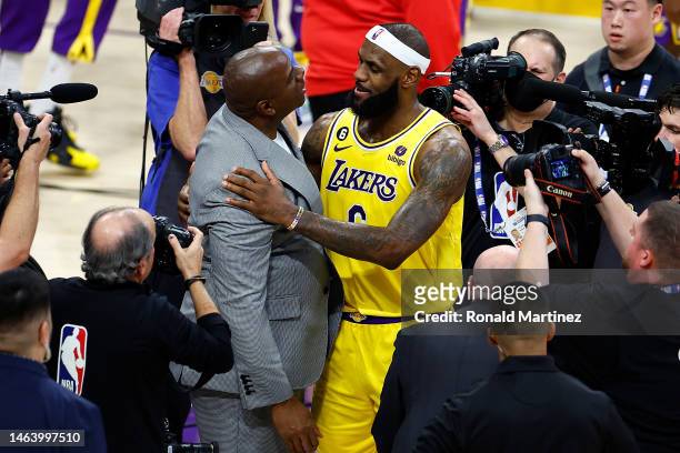 LeBron James of the Los Angeles Lakers celebrates with Magic Johnson after scoring to pass Kareem Abdul-Jabbar to become the NBA's all-time leading...