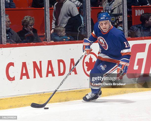 Darius Kasparaitis of the New York Islanders skates with the puck during a game against the Montreal Canadiens Circa 1993 at the Montreal Forum in...