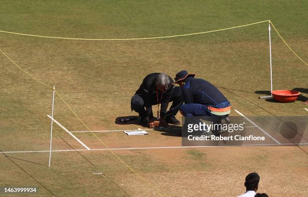 Groundskeepers are seen preparing the pitch prior to a Australia training session at Vidarbha Cricket Association Ground on February 08, 2023 in...