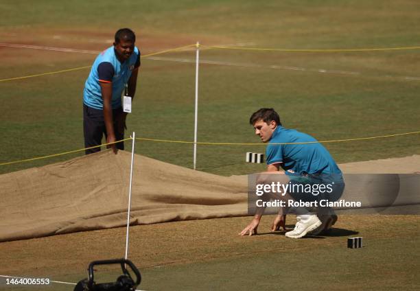 Pat Cummins of Australia inspects the pitch during a Australia training session at Vidarbha Cricket Association Ground on February 08, 2023 in...