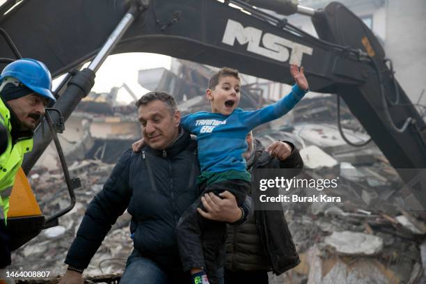 Rescue workers carry 8-year-old survivor Yigit Cakmak at the site of a collapsed building 52 hours after an earthquake struck on February 08, 2023 in...