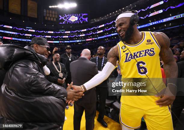 LeBron James of the Los Angeles Lakers celebrates with musician Usher at the end of the game after passing Kareem Abdul-Jabbar to become the NBA's...