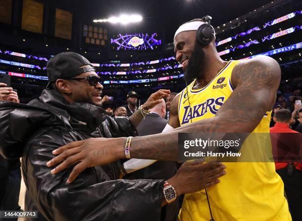 LeBron James of the Los Angeles Lakers celebrates with musician Usher at the end of the game after passing Kareem Abdul-Jabbar to become the NBA's...