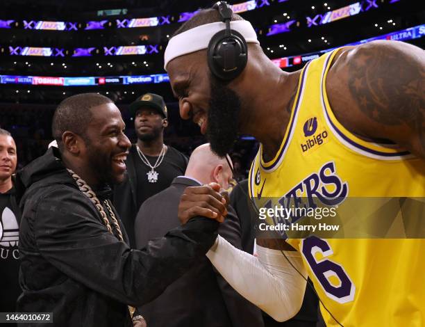 LeBron James of the Los Angeles Lakers celebrates with boxer Floyd Mayweather Jr. At the end of the game after passing Kareem Abdul-Jabbar to become...