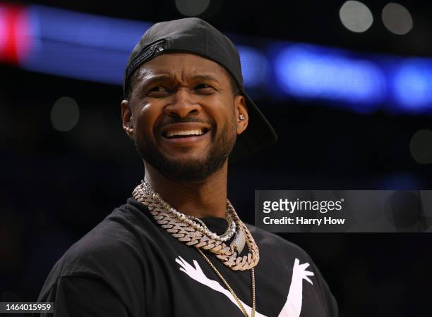 Usher reacts from the sidelines as he watches a game in which LeBron James of the Los Angeles Lakers passes Kareem Abdul-Jabbar to become the NBA's...