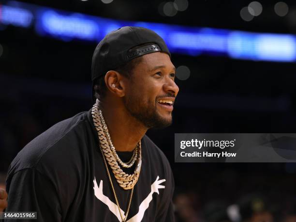 Usher reacts from the sidelines as he watches a game in which LeBron James of the Los Angeles Lakers passes Kareem Abdul-Jabbar to become the NBA's...