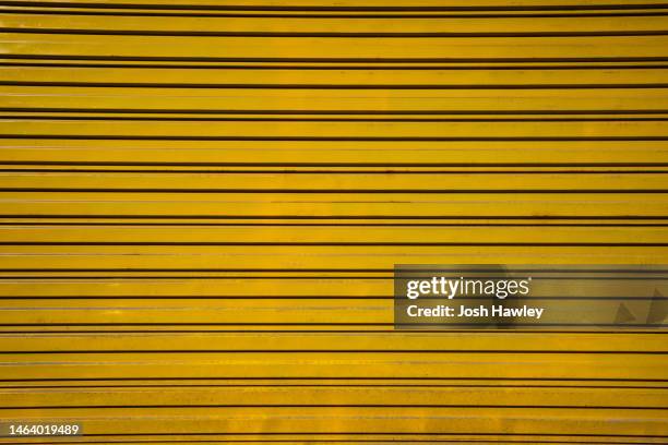 full frame shot of yellow wall - 波形鉄板 ストックフォトと画像