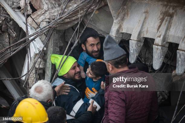 Rescue workers carry Yigit Cakmak, 8-years-old survivor at the site of a collapsed building 52 hours after the earthquake struck, on February 08,...