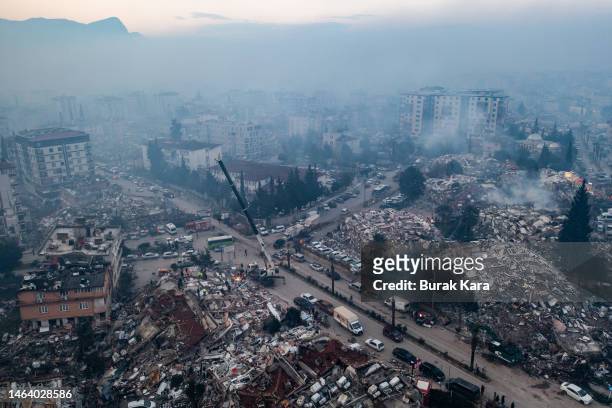 An aerial view shows smoke billowing from the scene of collapsed buildings on February 08, 2023 in Hatay, Turkey. A 7.8-magnitude earthquake hit near...
