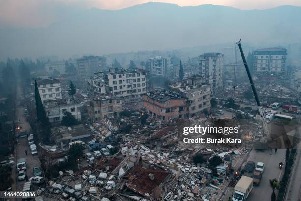 An aerial view shows rescue services at work at the scene of collapsed buildings on February 08, 2023 in Hatay, Turkey. A 7.8-magnitude earthquake...