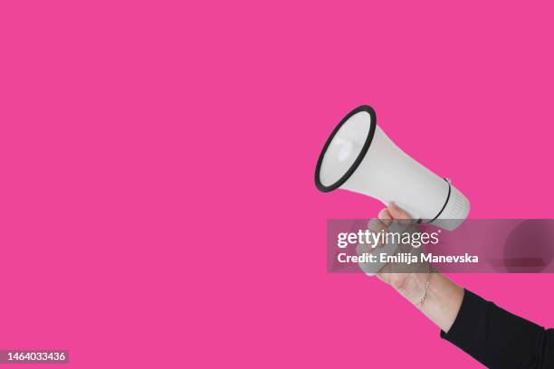 cropped hand of woman holding megaphone - activists hold vigil marking 50th anniversary of march on the pentagon stockfoto's en -beelden