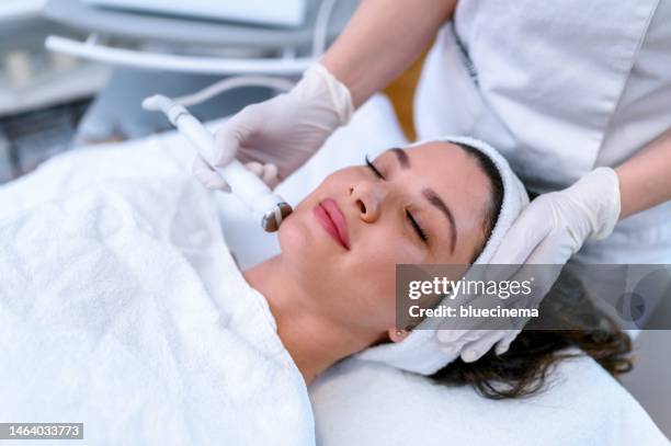 face treatment - facial massage stock pictures, royalty-free photos & images