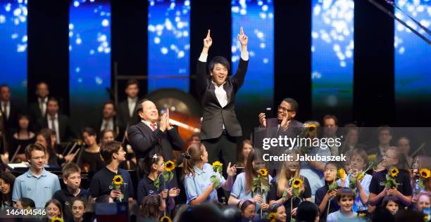 Chinese conductor Jahja Ling, Chinese pianist Lang Lang and US pianist Herbie Hancock perform live during a concert at the O2 World on June 15, 2012...