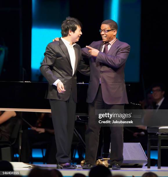 Chinese pianist Lang Lang and US pianist Herbie Hancock perform live during a concert at the O2 World on June 15, 2012 in Berlin, Germany.