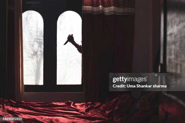 killer hiding behind the curtains. - murder stock-fotos und bilder
