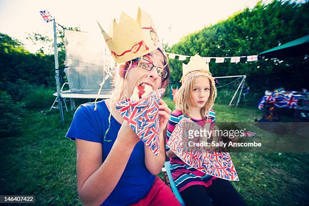 children eating burgers and hotdogs at a barbeque - british crown stock pictures, royalty-free photos & images