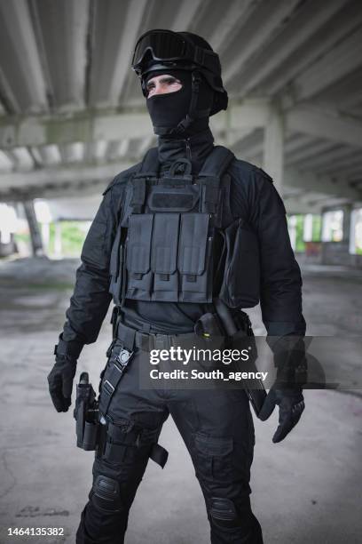young man standing in special force gear - bulletproof vest stock pictures, royalty-free photos & images