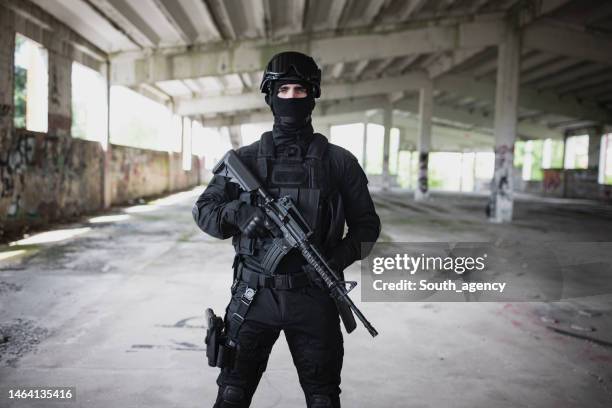 young man standing in special force gear - armed police stock pictures, royalty-free photos & images