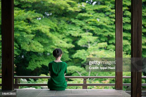 woman enjoying peaceful moment in kyoto - japansk trädgård bildbanksfoton och bilder