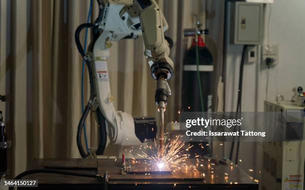 robot welding is welding assembly automotive part in  factory - arms of steel stock pictures, royalty-free photos & images