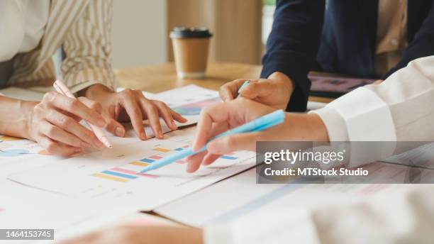 closeup of multiethnic team of businesspeople brainstorm on project during corporate meeting in the office. financial company. - mesa de reunião imagens e fotografias de stock